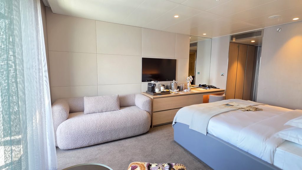 Balcony suite, lounge area and cabinet on the Emerald Kaia