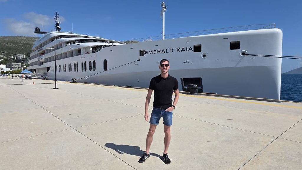 Marketing Manager, Blake Hatton, in front of the Emerald Cruises superyacht, the Emerald Kaia