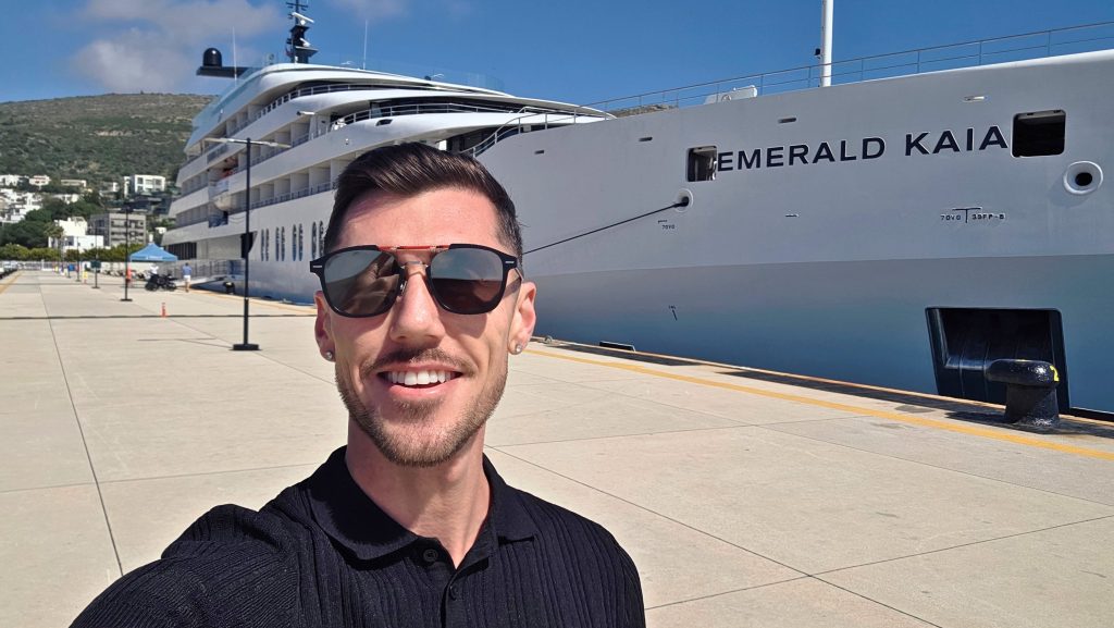 Marketing Manager, Blake Hatton, in front of the Emerald Kaia Superyacht