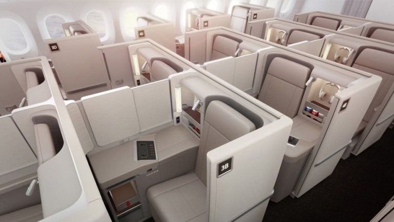 Business class airline cabin with private lie-flat seats in individual suites, seat 3A visible.
